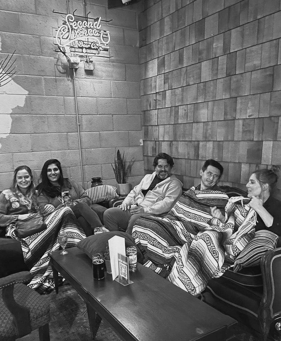 A group of Censys employees hanging out on couches at a brewery.